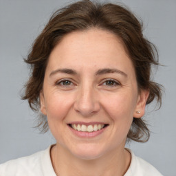 Joyful white adult female with medium  brown hair and brown eyes