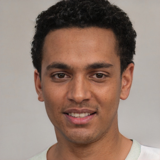 Joyful white young-adult male with short  black hair and brown eyes