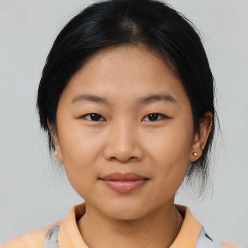 Joyful asian young-adult female with medium  black hair and brown eyes