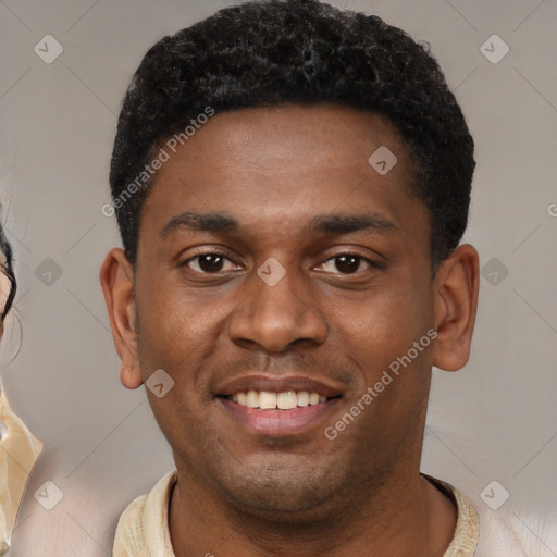 Joyful black young-adult male with short  black hair and brown eyes