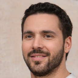 Joyful white young-adult male with short  black hair and brown eyes