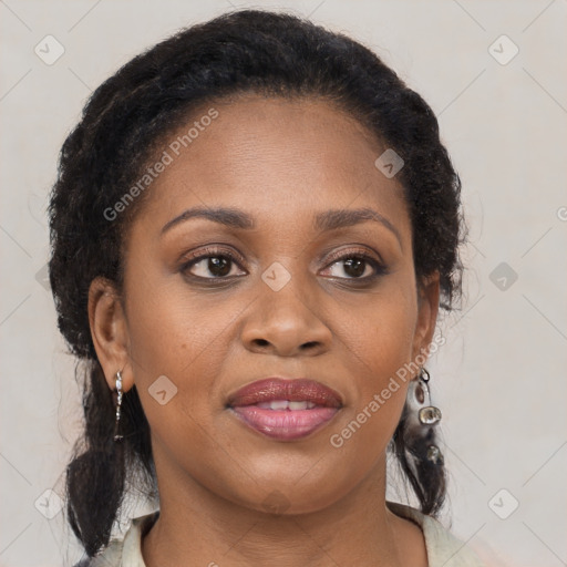 Joyful black young-adult female with long  brown hair and brown eyes