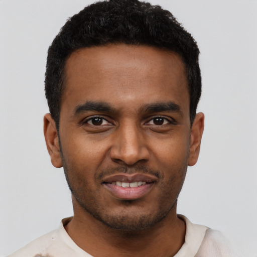 Joyful black young-adult male with short  black hair and brown eyes