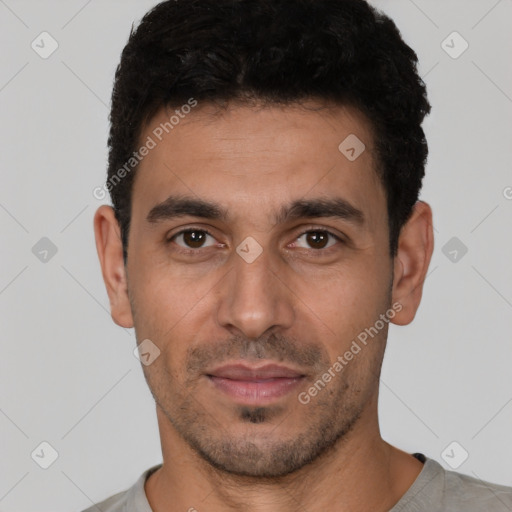 Joyful white young-adult male with short  black hair and brown eyes