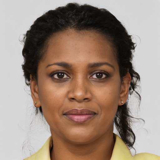 Joyful black young-adult female with medium  brown hair and brown eyes
