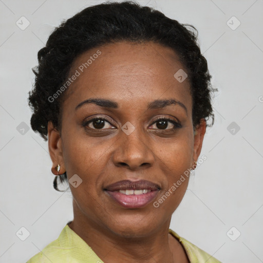 Joyful black adult female with short  brown hair and brown eyes