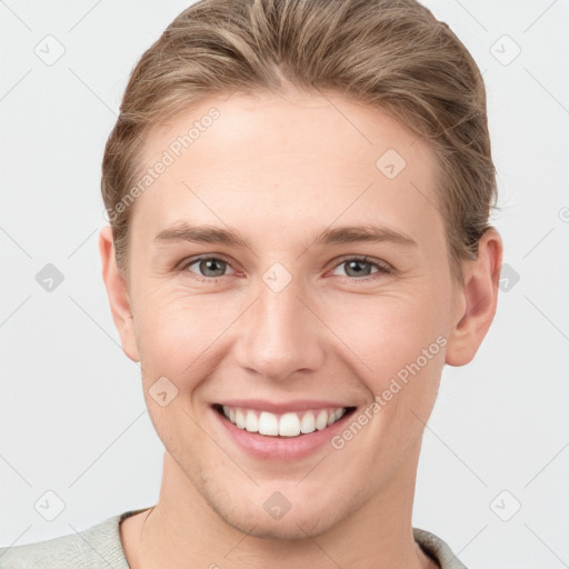 Joyful white young-adult female with short  brown hair and grey eyes