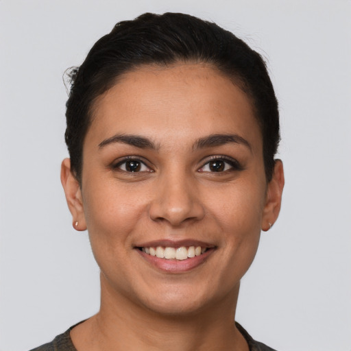 Joyful latino young-adult female with short  brown hair and brown eyes