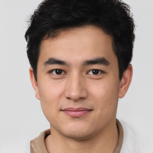 Joyful latino young-adult male with short  brown hair and brown eyes