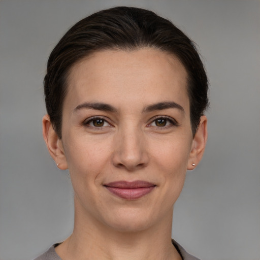 Joyful white young-adult female with short  brown hair and brown eyes