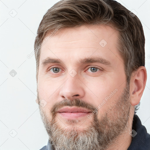 Joyful white adult male with short  brown hair and grey eyes