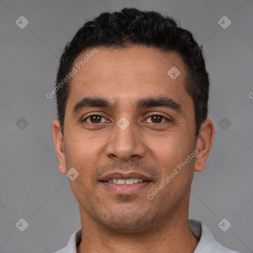 Joyful white young-adult male with short  black hair and brown eyes