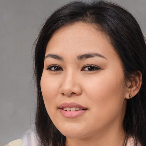 Joyful asian young-adult female with medium  brown hair and brown eyes