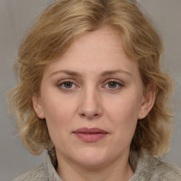 Joyful white adult female with medium  brown hair and grey eyes