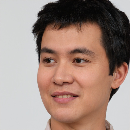 Joyful asian young-adult male with short  black hair and brown eyes