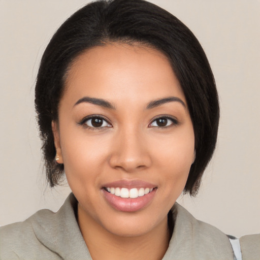 Joyful latino young-adult female with medium  black hair and brown eyes