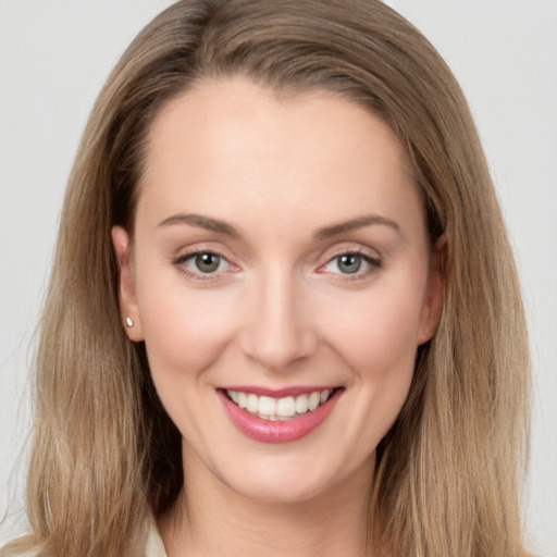 Joyful white young-adult female with long  brown hair and brown eyes