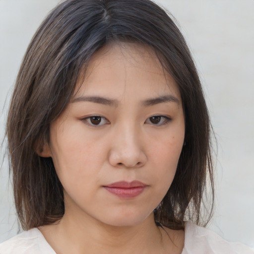 Neutral asian young-adult female with medium  brown hair and brown eyes