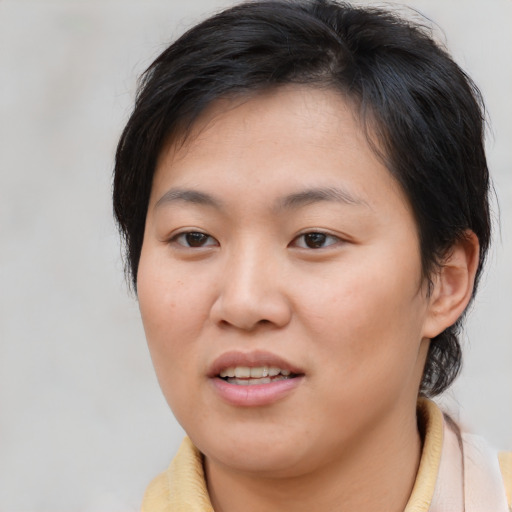 Joyful asian young-adult female with short  brown hair and brown eyes