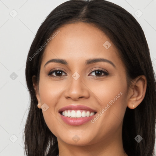 Joyful latino young-adult female with long  brown hair and brown eyes