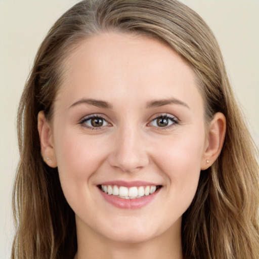 Joyful white young-adult female with long  brown hair and blue eyes