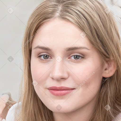 Joyful white young-adult female with long  brown hair and blue eyes