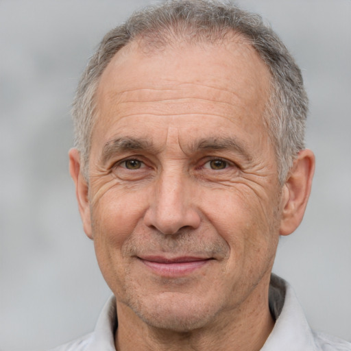 Joyful white middle-aged male with short  gray hair and brown eyes