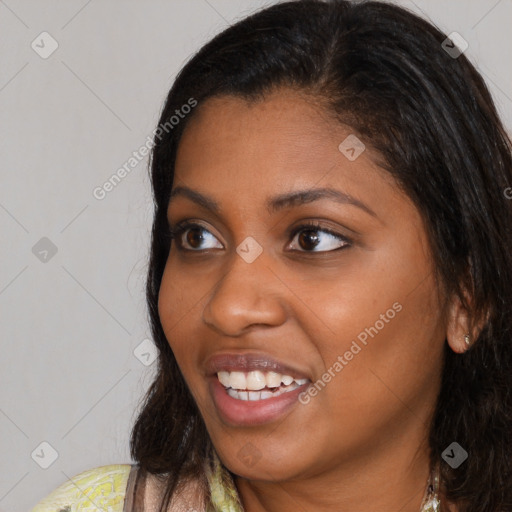 Joyful latino young-adult female with long  brown hair and brown eyes