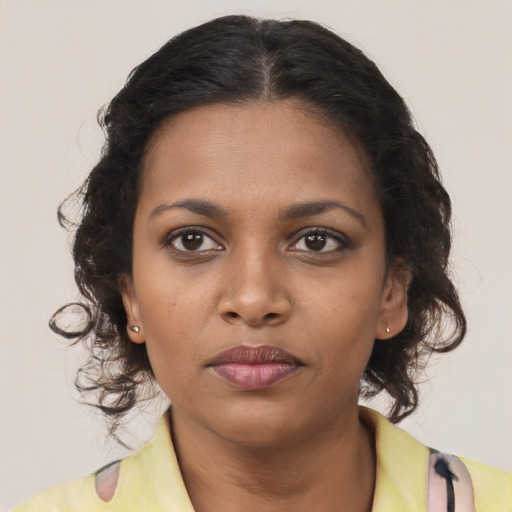 Neutral black young-adult female with medium  brown hair and brown eyes