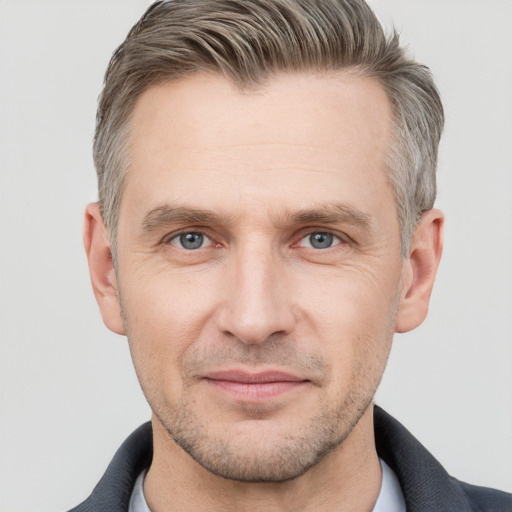 Joyful white adult male with short  brown hair and grey eyes