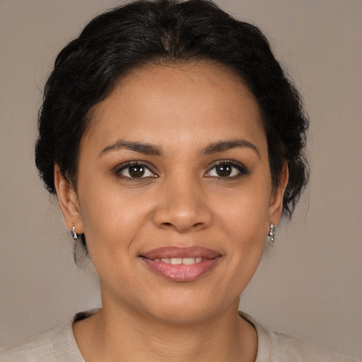 Joyful latino young-adult female with medium  brown hair and brown eyes