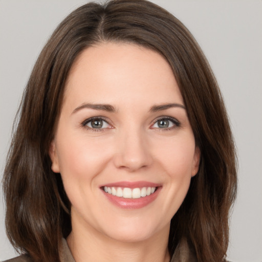 Joyful white young-adult female with medium  brown hair and brown eyes