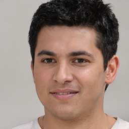 Joyful white young-adult male with short  black hair and brown eyes
