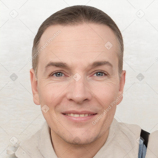 Joyful white adult male with short  brown hair and grey eyes