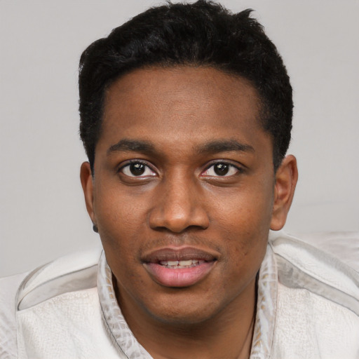 Joyful black young-adult male with short  black hair and brown eyes