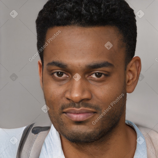 Joyful black young-adult male with short  brown hair and brown eyes