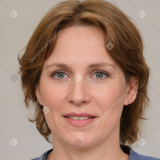 Joyful white adult female with medium  brown hair and blue eyes