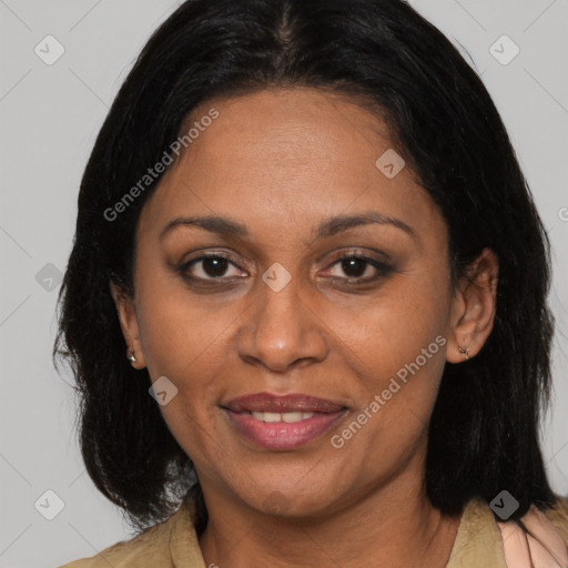 Joyful latino adult female with medium  brown hair and brown eyes