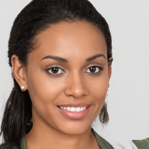 Joyful latino young-adult female with long  brown hair and brown eyes