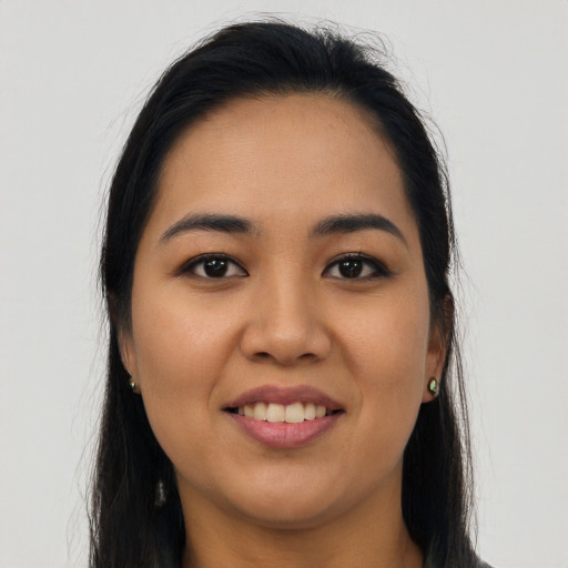 Joyful latino young-adult female with long  black hair and brown eyes