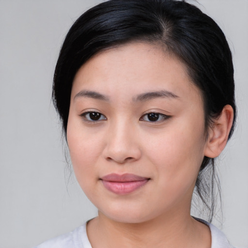 Joyful asian young-adult female with medium  black hair and brown eyes
