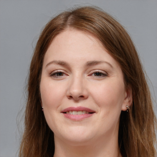 Joyful white young-adult female with long  brown hair and grey eyes