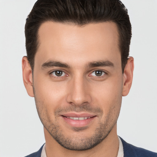 Joyful white young-adult male with short  brown hair and brown eyes