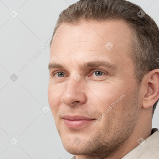 Joyful white adult male with short  brown hair and brown eyes