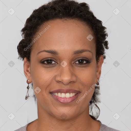 Joyful black young-adult female with short  brown hair and brown eyes