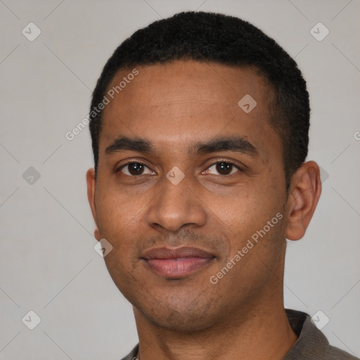 Joyful black young-adult male with short  black hair and brown eyes