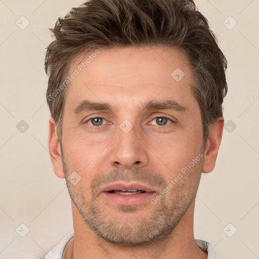 Joyful white adult male with short  brown hair and brown eyes