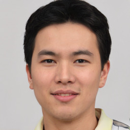 Joyful asian young-adult male with short  black hair and brown eyes