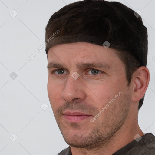 Joyful white adult male with short  brown hair and brown eyes