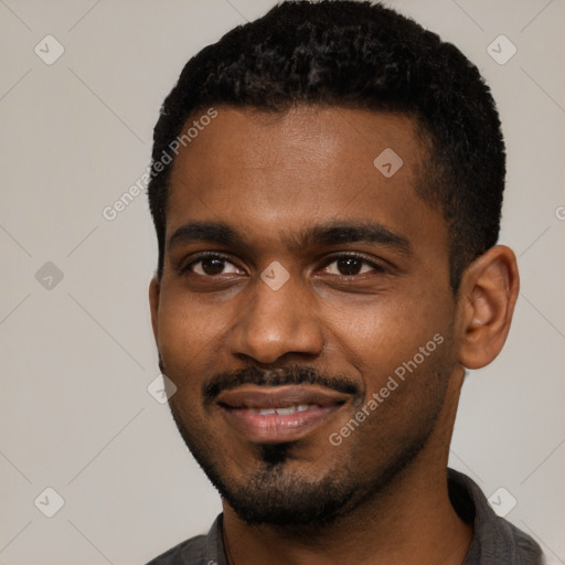 Joyful black young-adult male with short  black hair and brown eyes